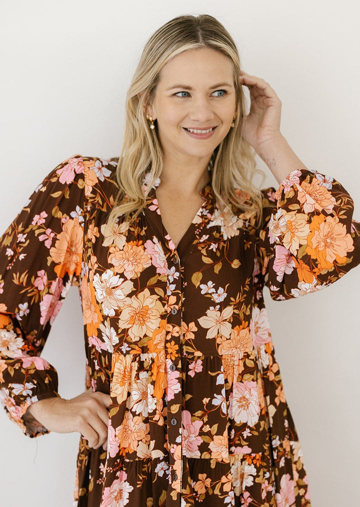 plus-size brown floral smock-style knee-length dress with long sleeves and pockets