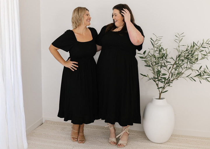 Black midi dress with shirred bodice and lined skirt