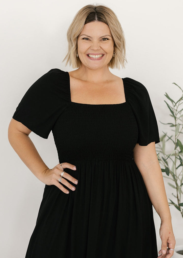 Women's black midi dress with shirred bodice