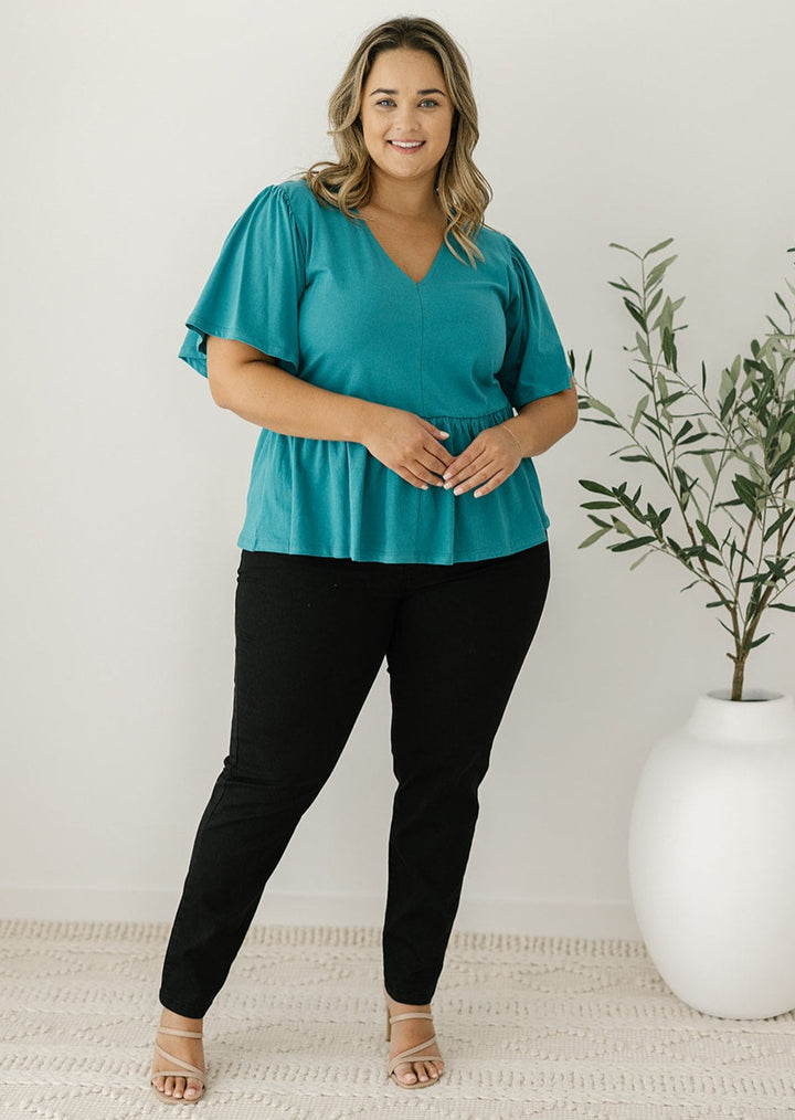 women's peplum-style top in teal