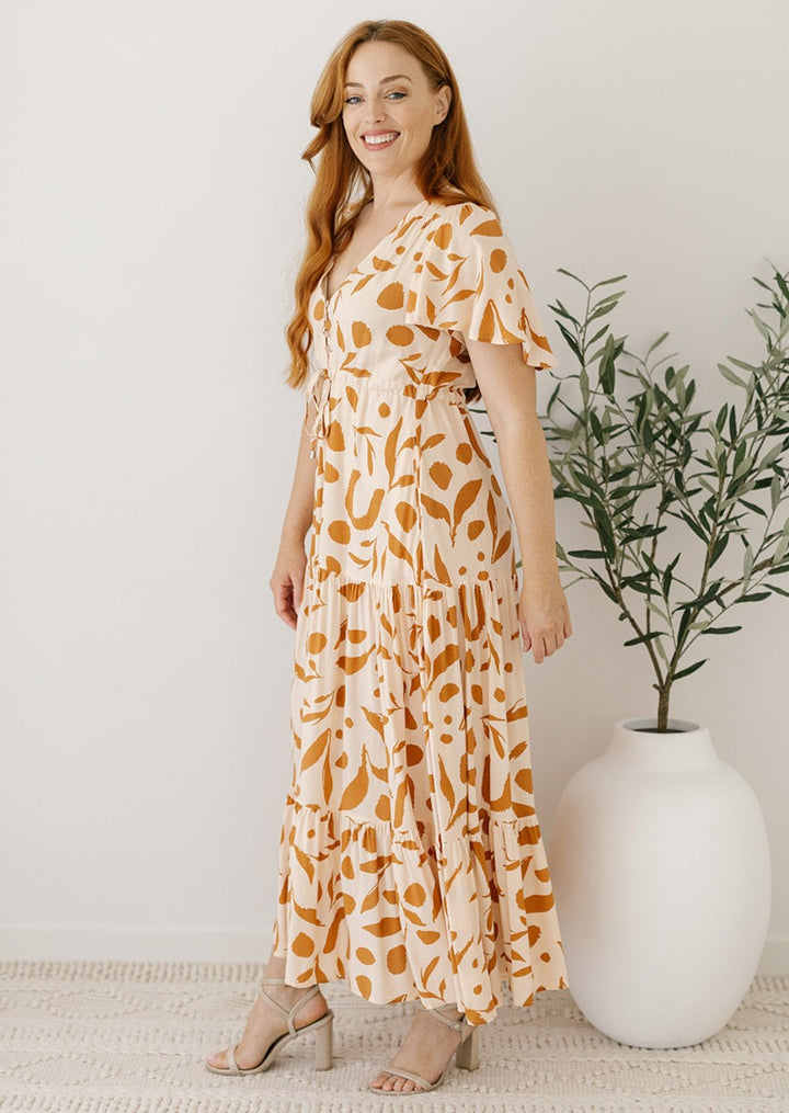 cream and tan maxi dress with drawstring waist and pockets