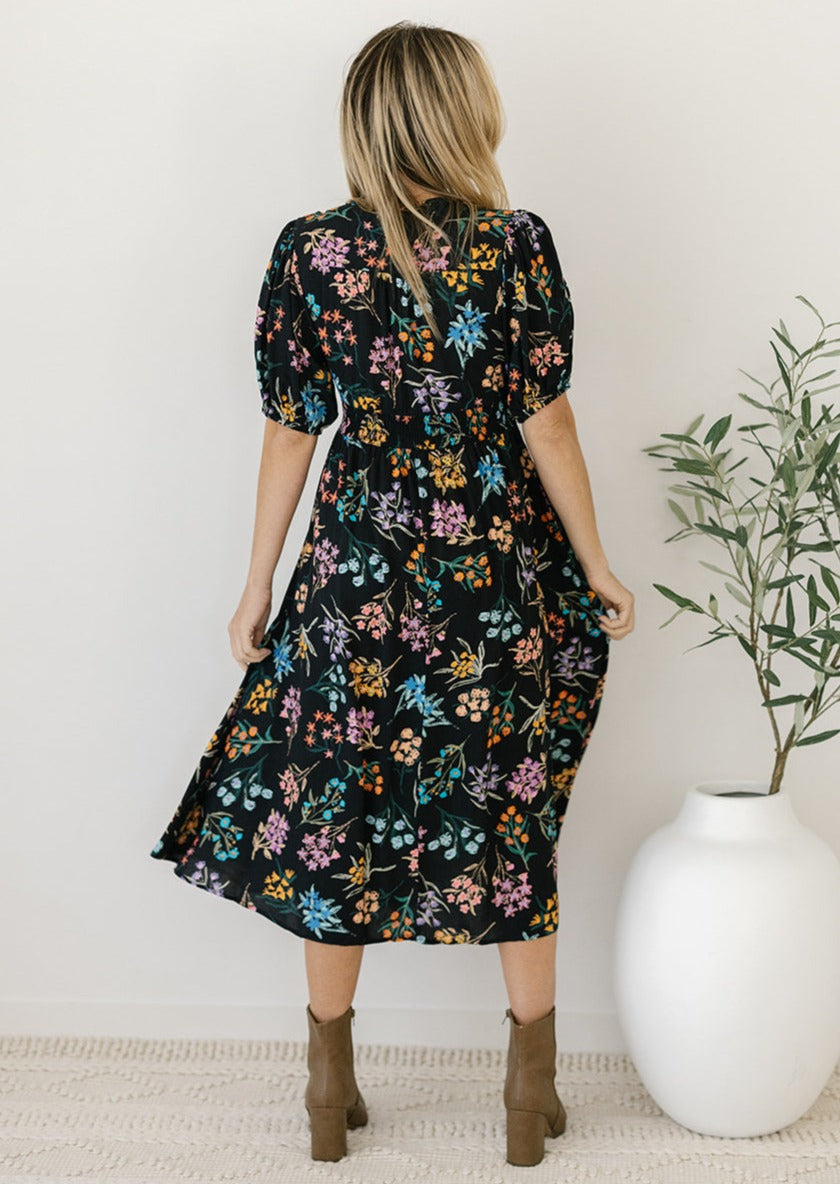 black and floral midi dress with sleeves and pockets