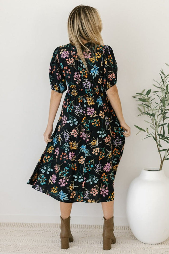 black and floral midi dress with sleeves and pockets