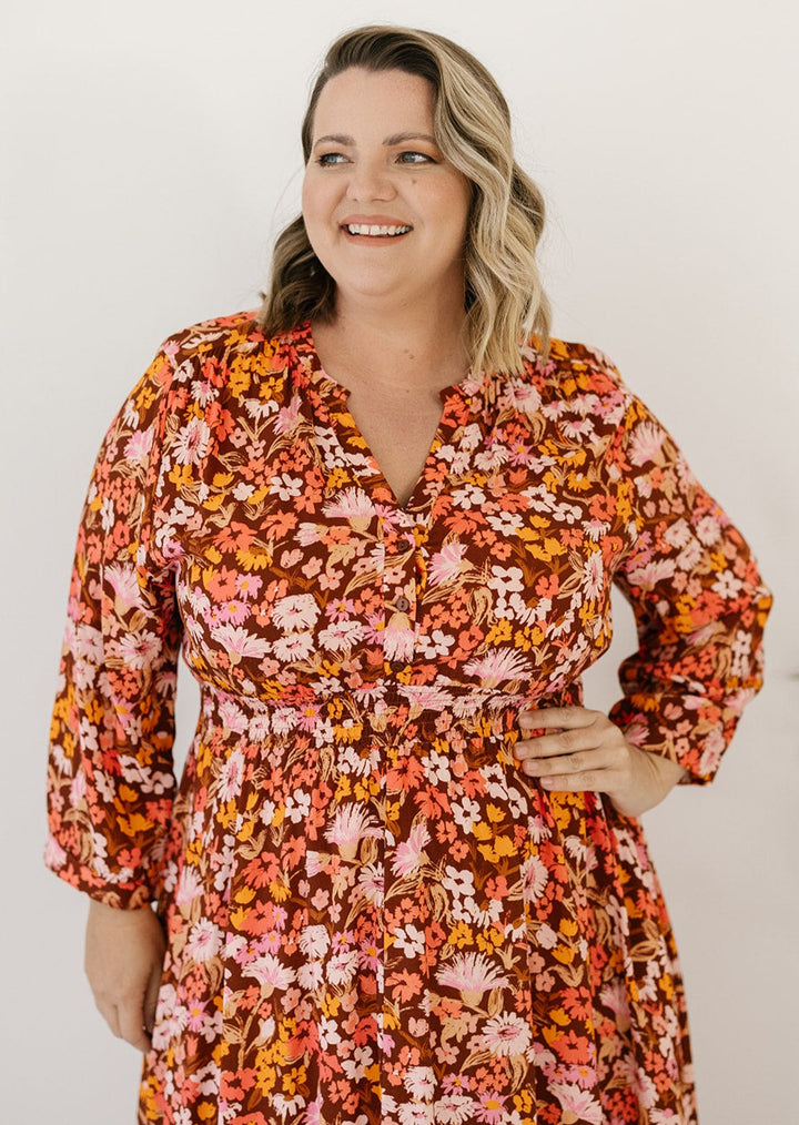 brown and orange floral midi dress with pockets and long-sleeves