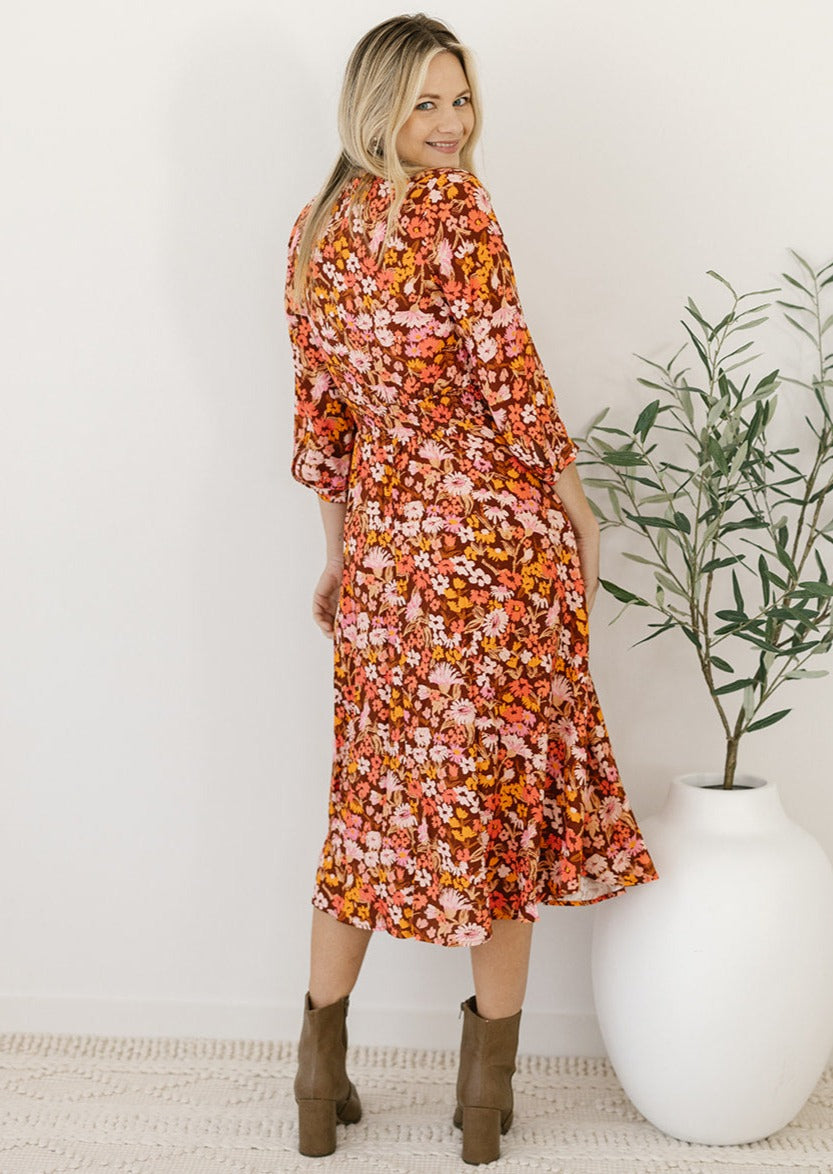 brown and orange floral midi dress with elastic waist and long sleeves
