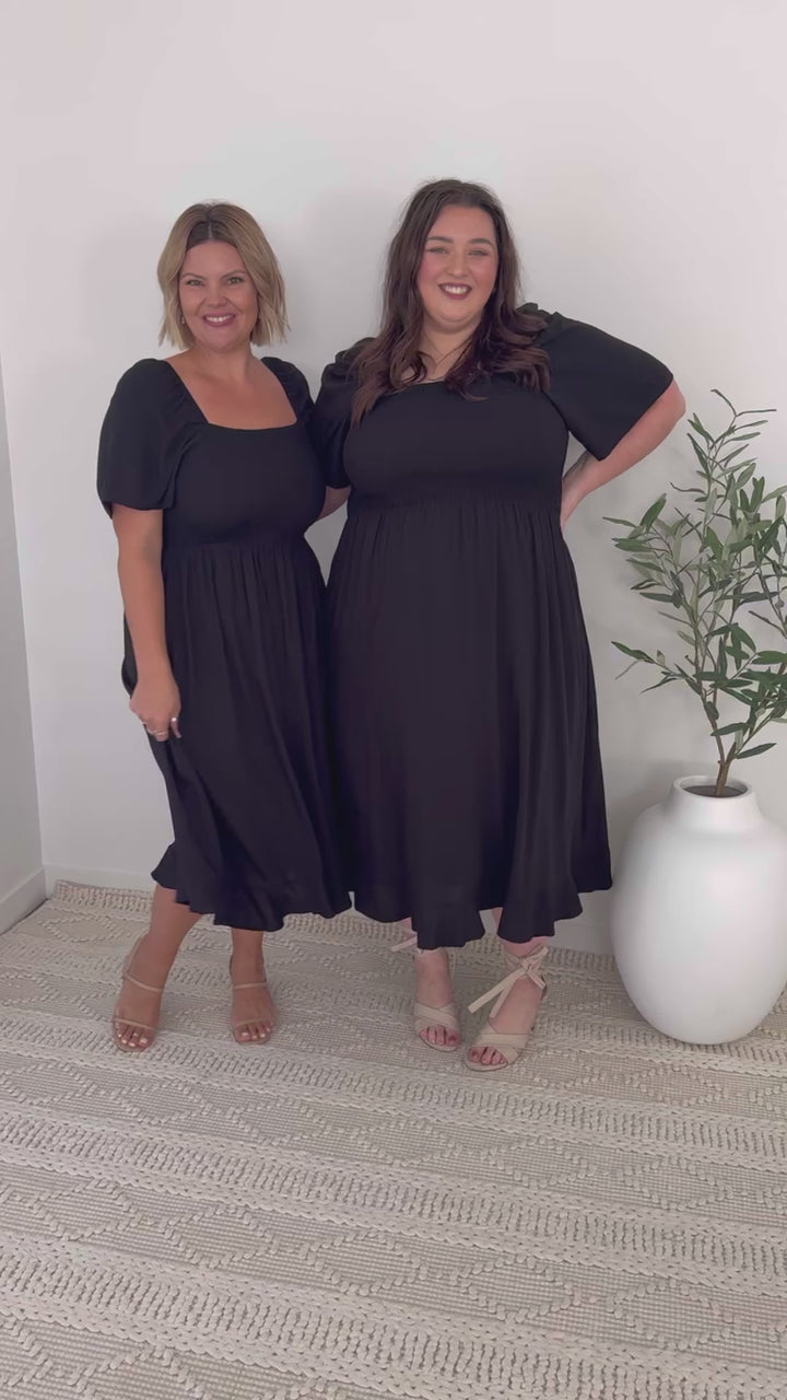 Black midi dress with shirred bodice and short sleeves