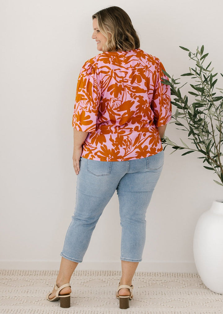 pink and orange floral blouse with buttons