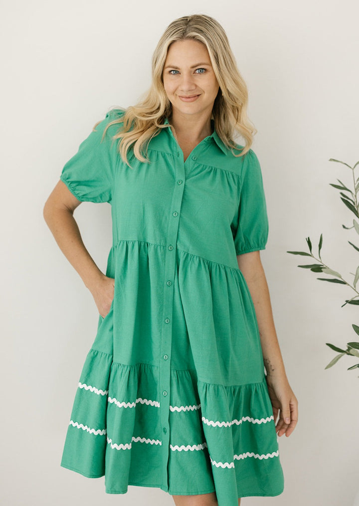 green knee-length button-down dress with pockets