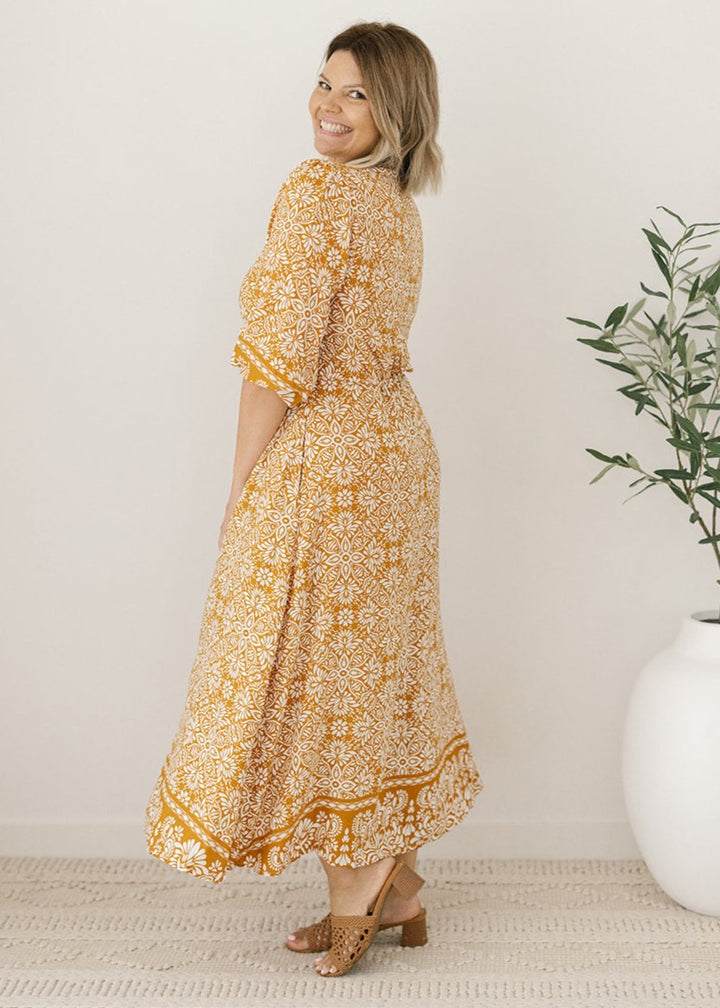women's mustard and white floral print midi dress with pockets