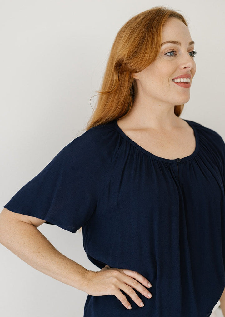 block navy top with flutter sleeves and front button closure