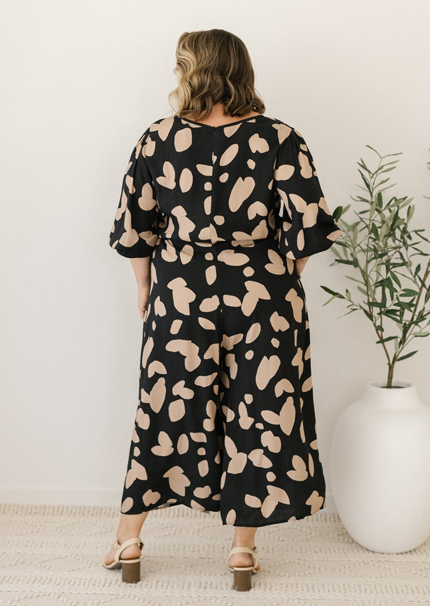 black and tan abstract print jumpsuit with drawstring waist and pockets