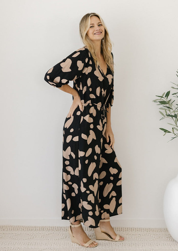 black and tan petal print jumpsuit with 3/4 length sleeves