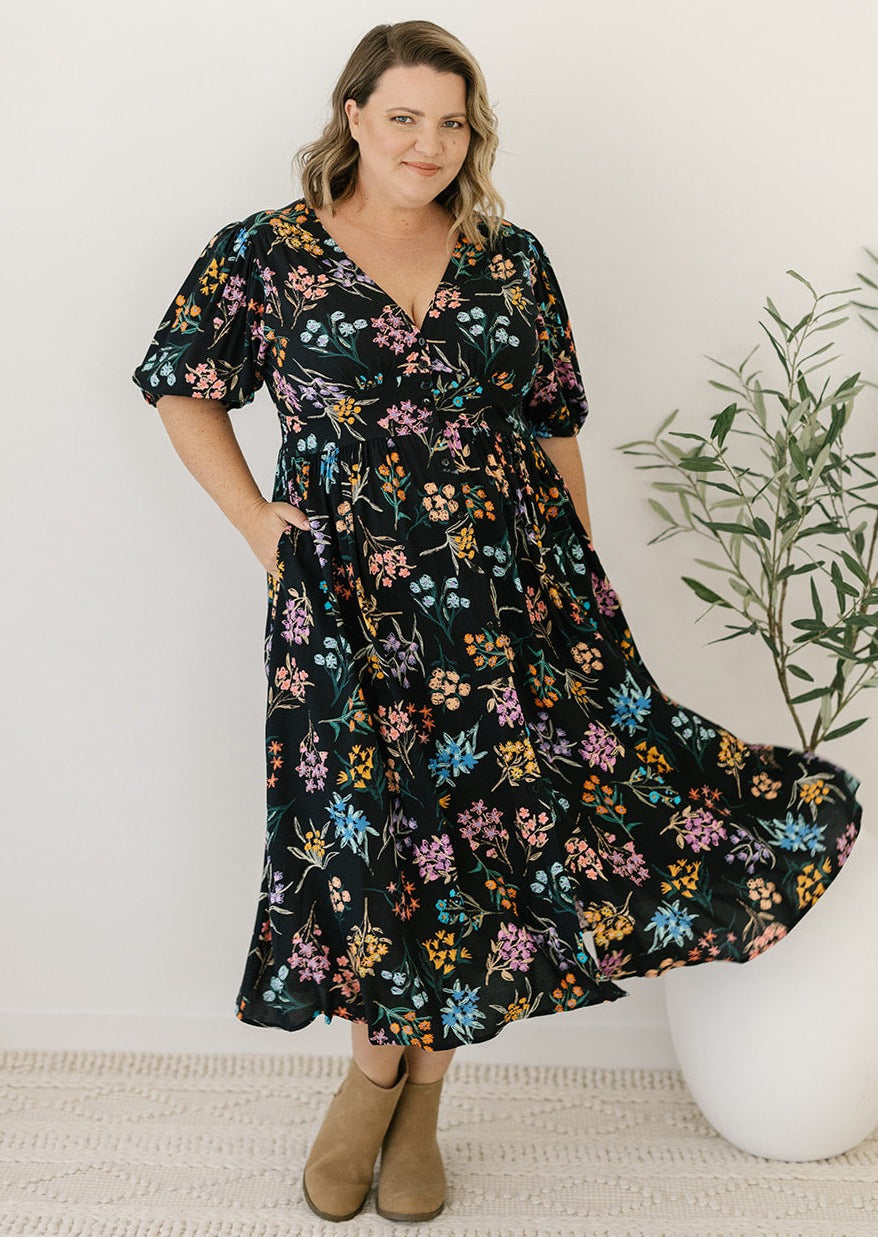 plus-size black and floral midi dress with pockets