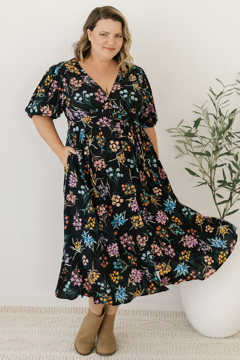 plus-size black and floral midi dress with pockets