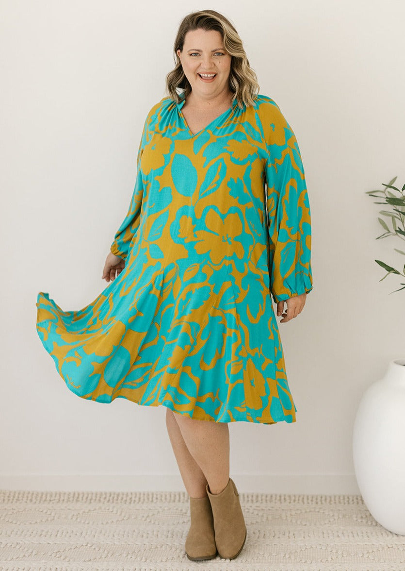 teal and mustard floral knee-length long-sleeved dress
