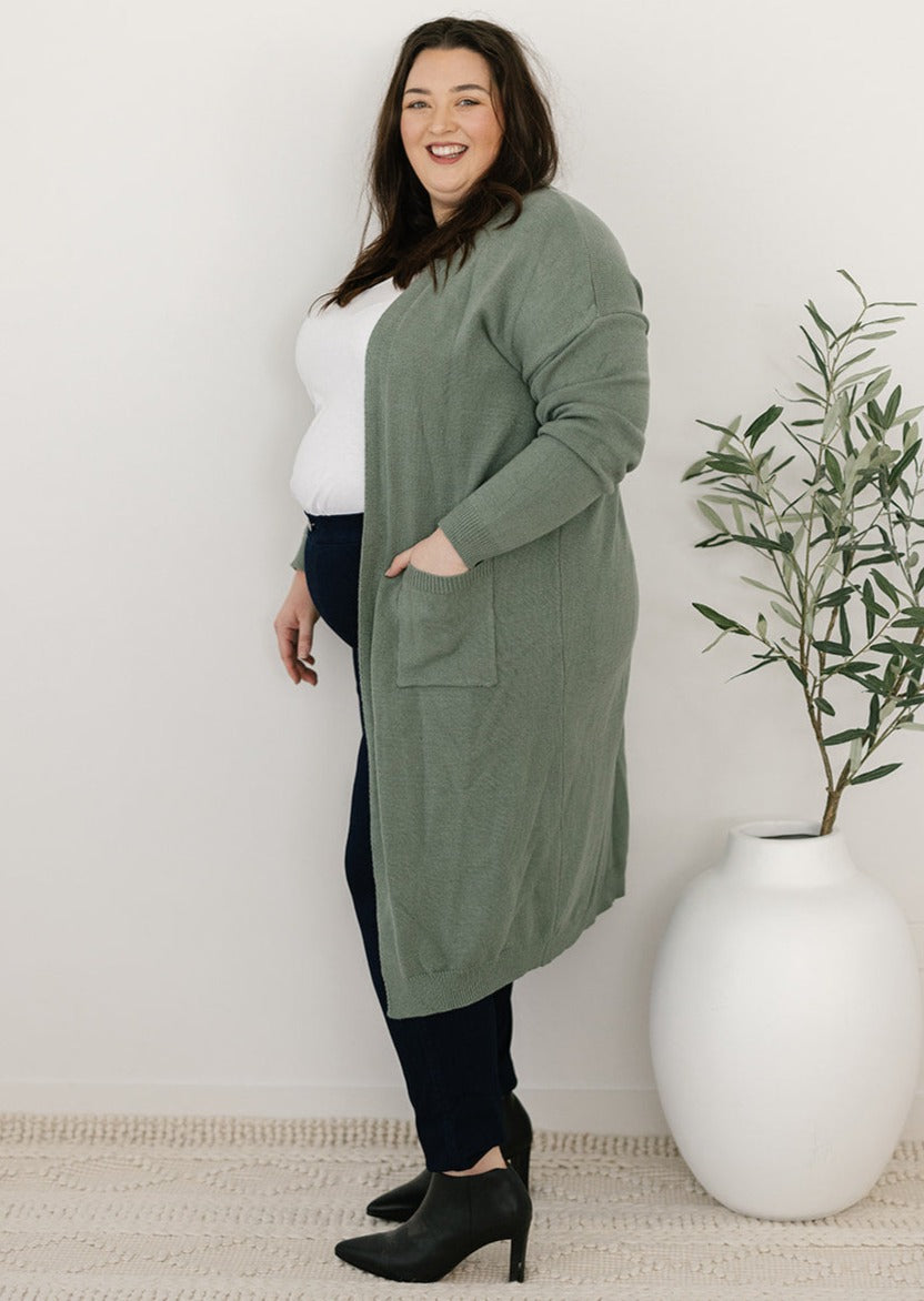 Plus-size green knit cardigan with pockets