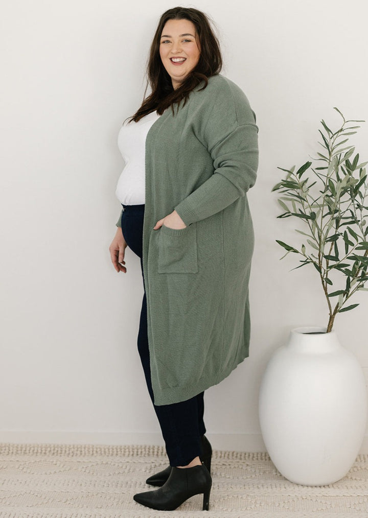 Plus-size green knit cardigan with pockets